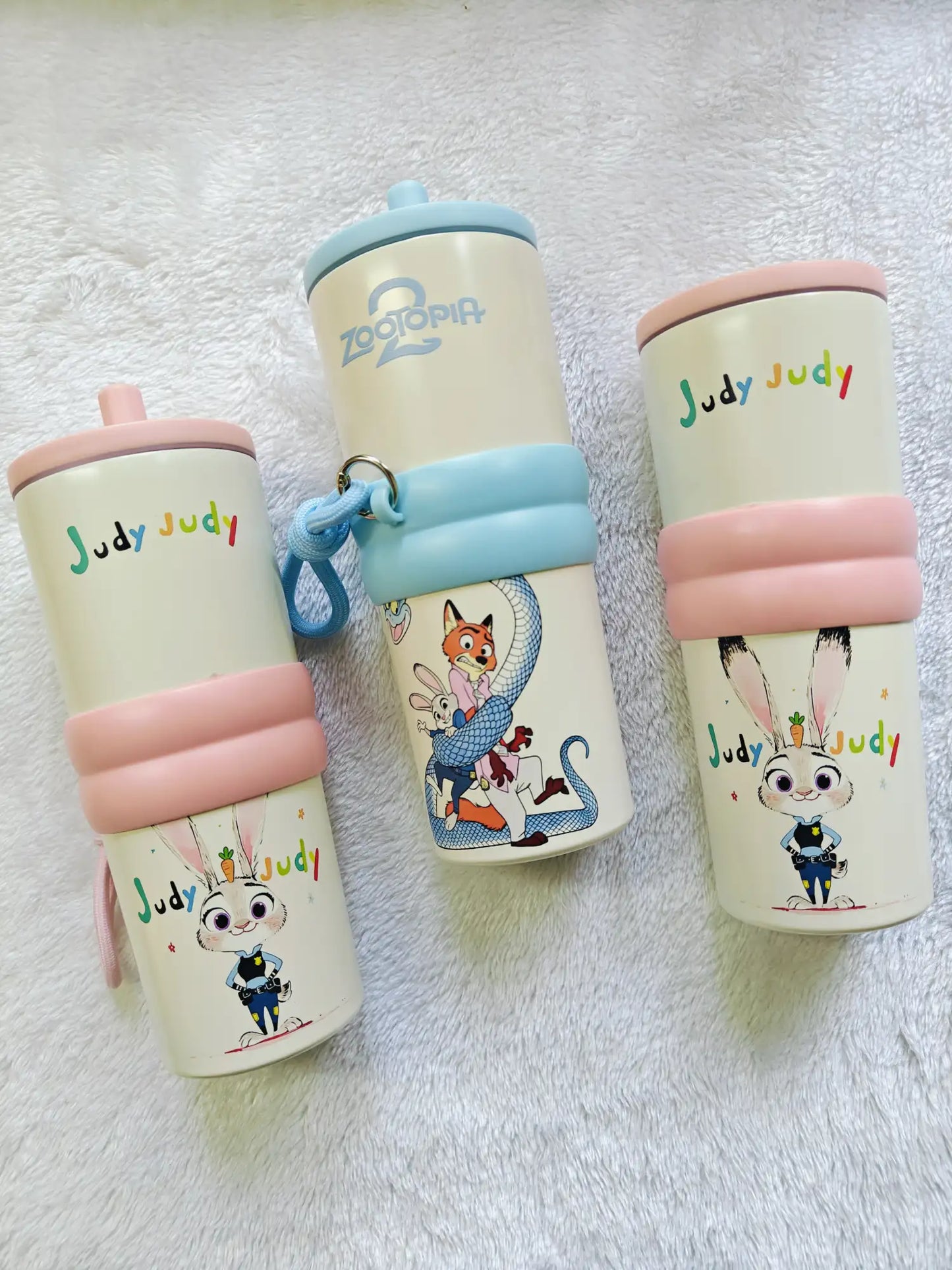 Three children's cups with cartoon characters on a white background