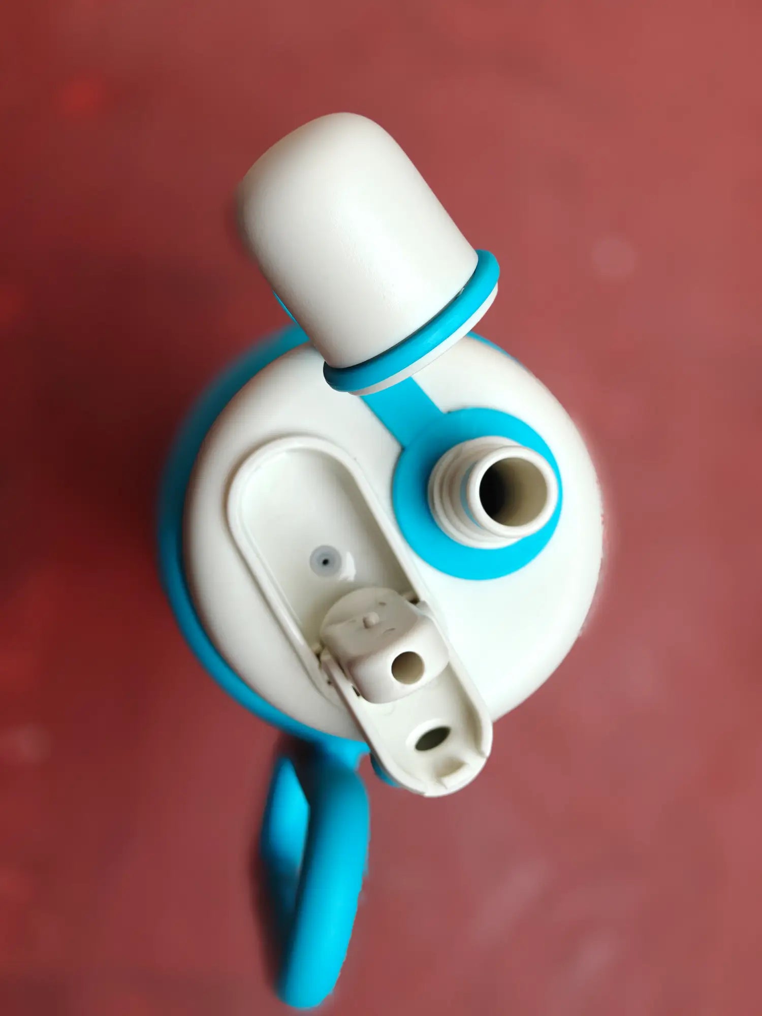 White and blue tumbler with a hose on a red background