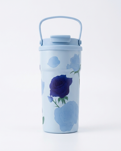 A light blue insulated travel tumbler with a matching lid and carry handle, decorated with a dark blue rose and light blue floral motifs, on a white background.
