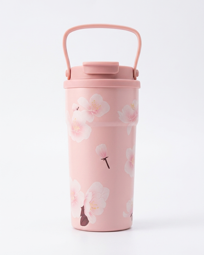 A light pink insulated travel tumbler with a matching handle lid and a delicate cherry blossom floral pattern, shown on a clean white background.