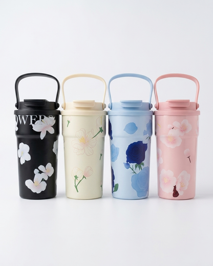 Four reusable metal water bottles with carrying handles lined up on a white background. From left to right: a black bottle with white floral print and partial white lettering, a cream bottle with pale yellow flowers, a light blue bottle with dark blue flowers, and a pink bottle with light pink flowers.
