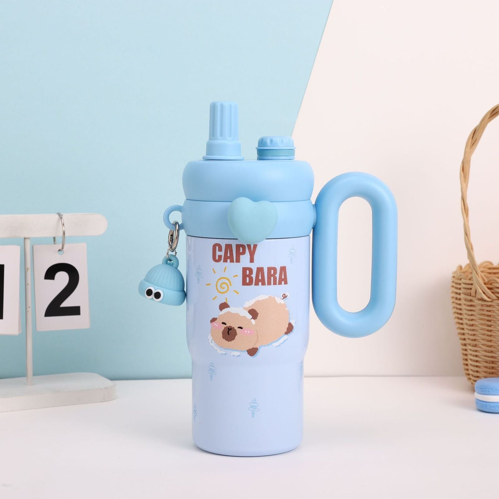 Blue water bottle with cartoon character and 'Capy Bara' text on a light blue background