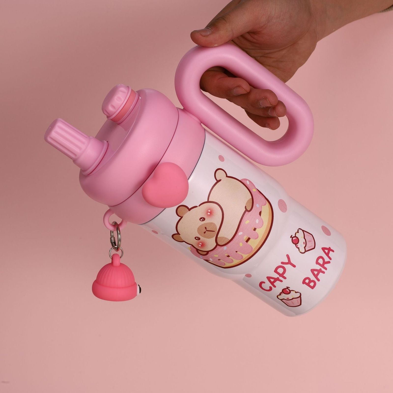 Pink Capy Bara tumbler showing ergonomic handle and spill-proof lid with heart accent