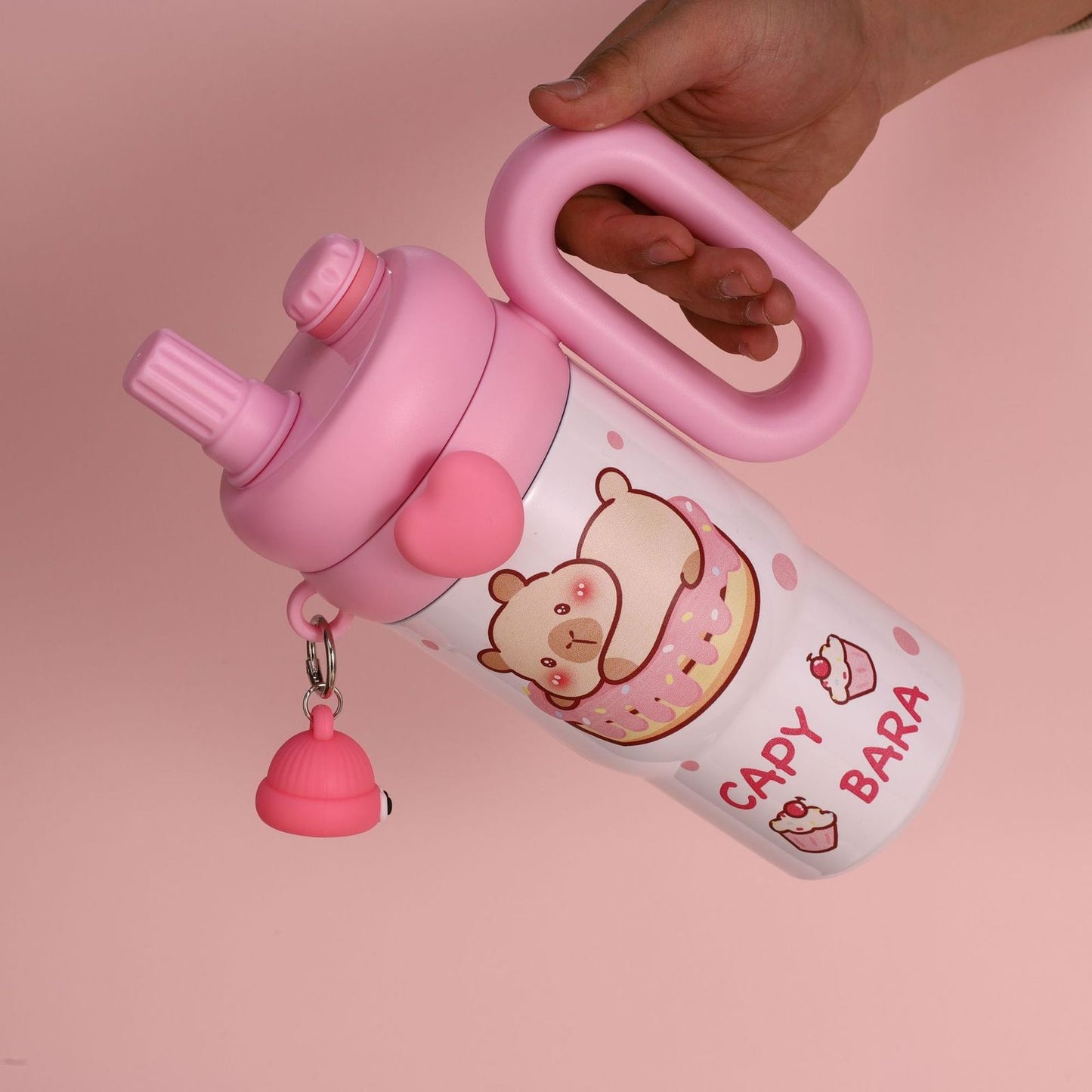Pink Capy Bara tumbler showing ergonomic handle and spill-proof lid with heart accent