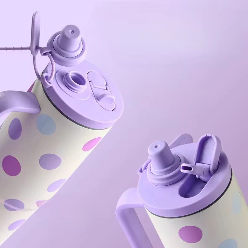 Two purple and white polka dot bottles on a light purple background