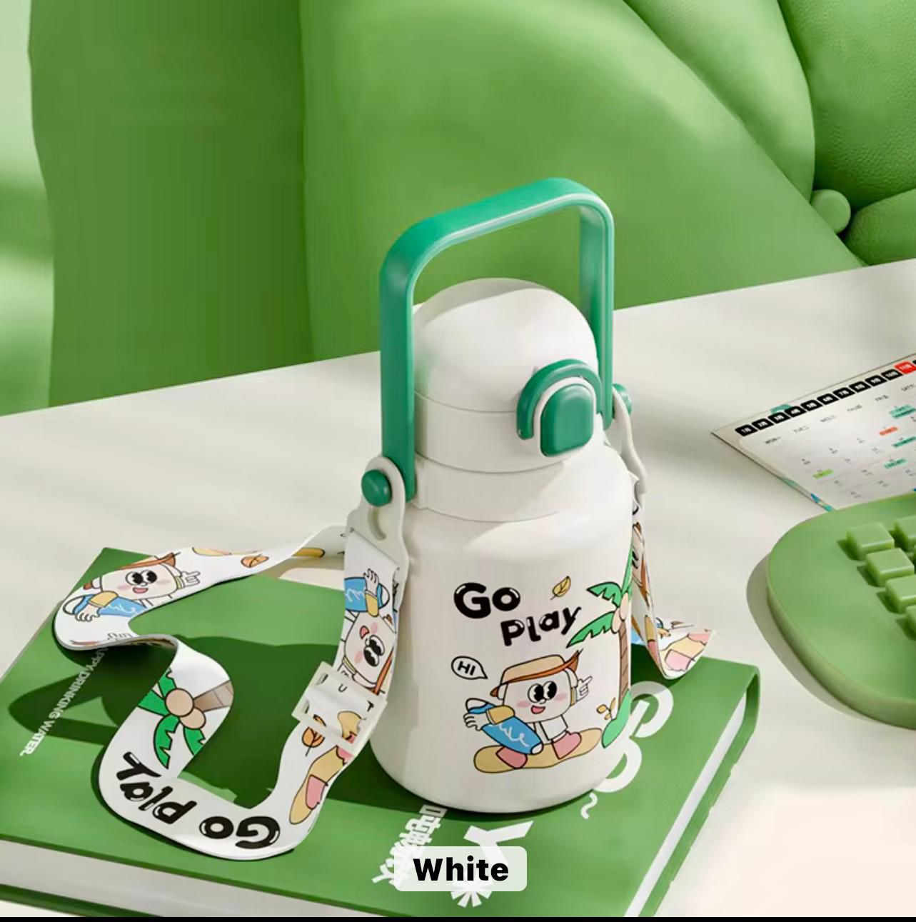 White water bottle with green handle and cartoon character design on a green surface