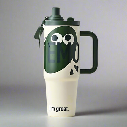 White tumbler with green lid and handle, featuring a smiley face and 'I'm great.' text on a gray background