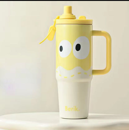 Yellow mug with cartoon face design on a light background