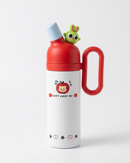 A white stainless steel water bottle with a red lid and carrying loop, featuring a cute cartoon apple character and the text 'HAPPY EVERY DAY!' on the front. A small green bunny figure is perched on top of the red lid.