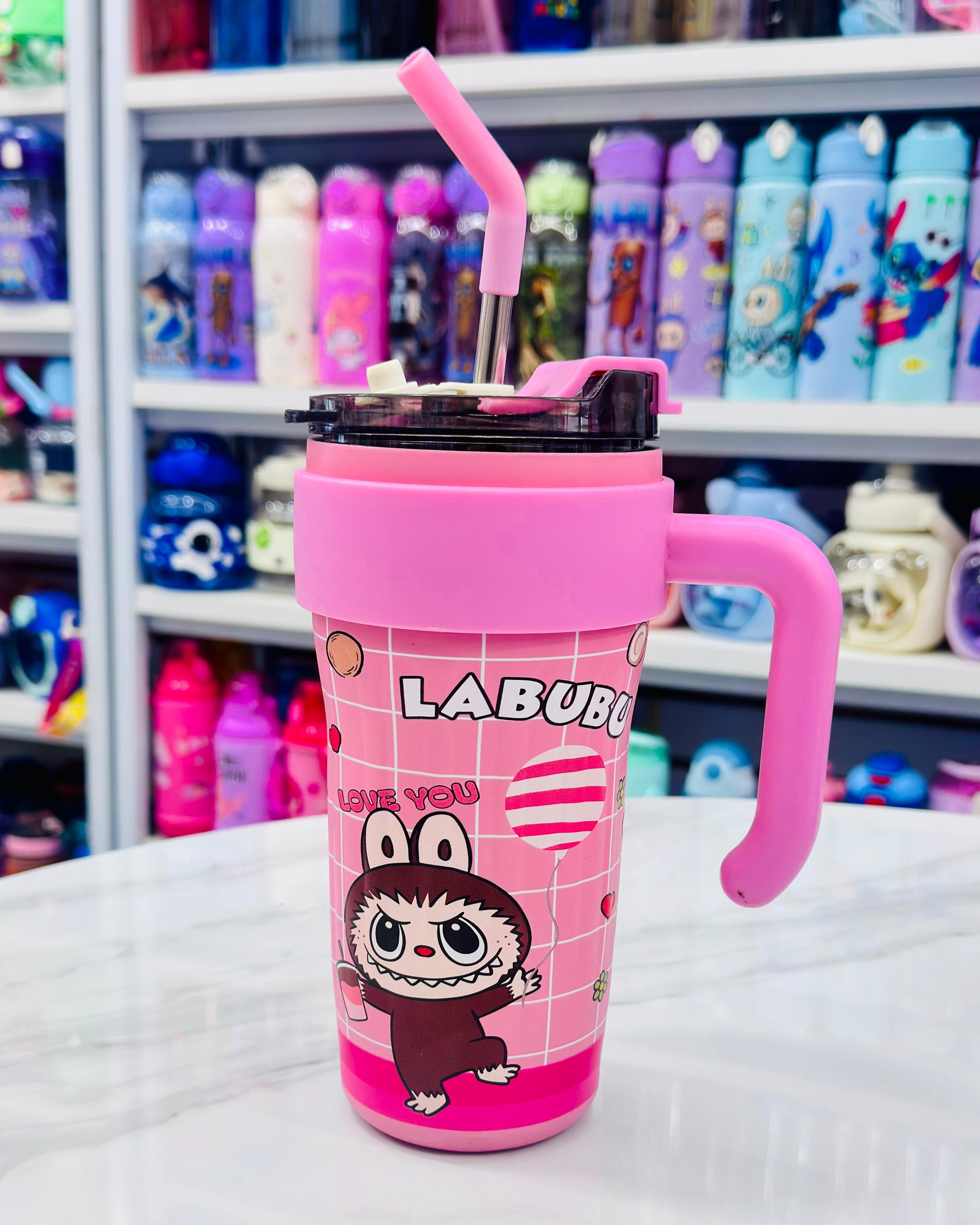 Labubu 860ml insulated tumbler in pink with character design, steel straw, and handle