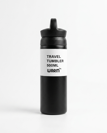 A matte black travel tumbler bottle with a black flip-top lid and a white label featuring the text 'TRAVEL TUMBLER 500ML WARM' in black.