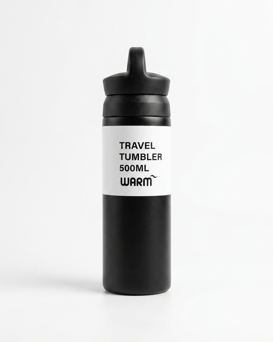 A matte black travel tumbler bottle with a black flip-top lid and a white label featuring the text 'TRAVEL TUMBLER 500ML WARM' in black.