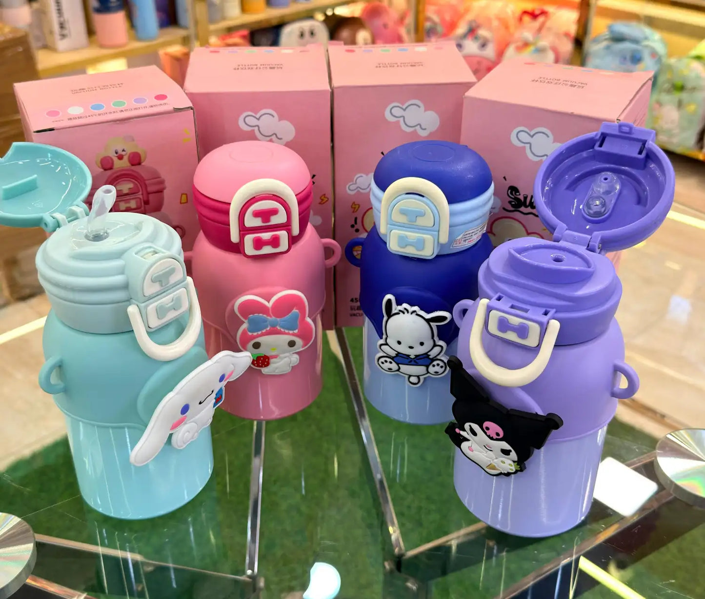 Colorful children's water bottles with cartoon character designs on a display stand.