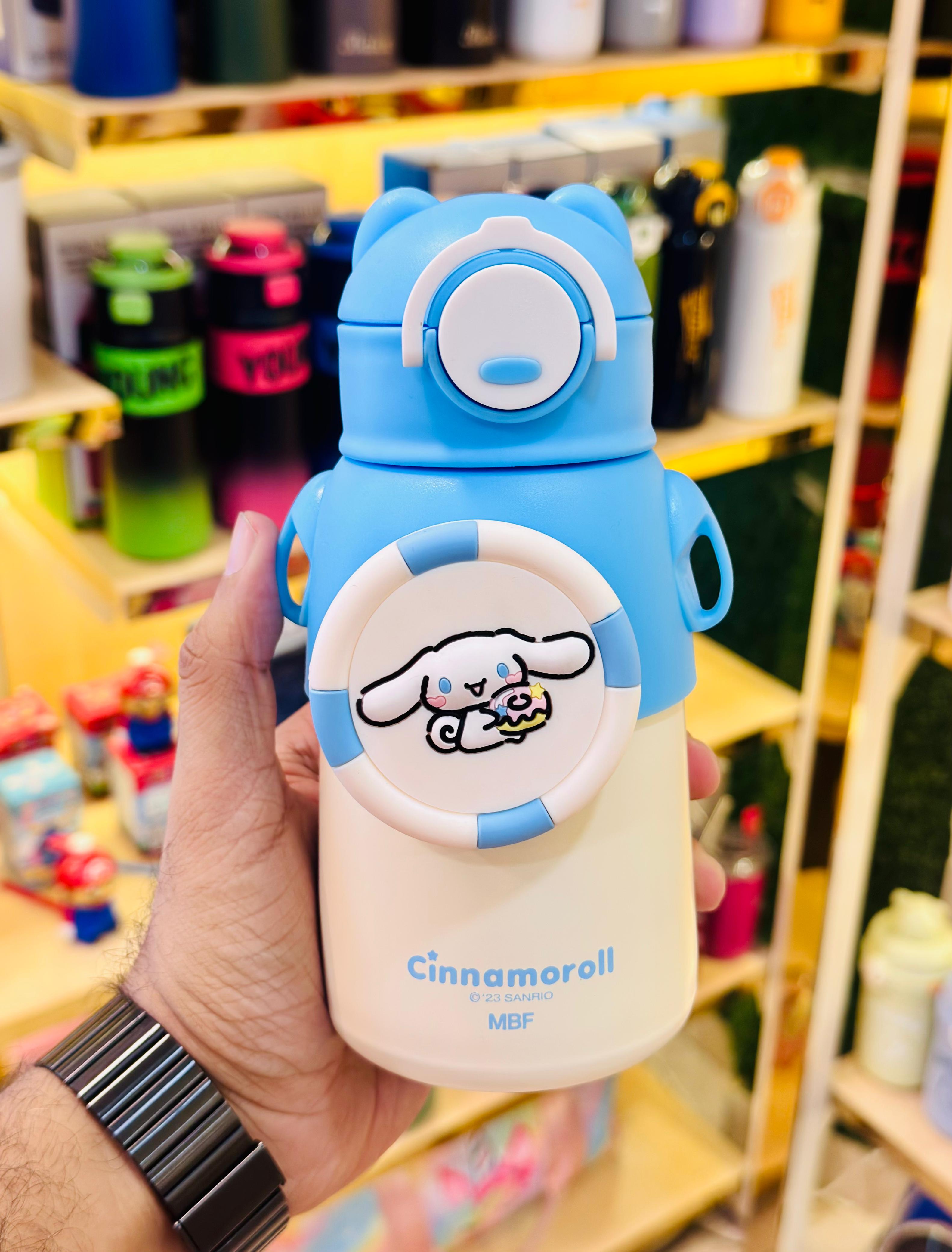 Cartoon character-themed water bottle held in a hand with a blurred store background