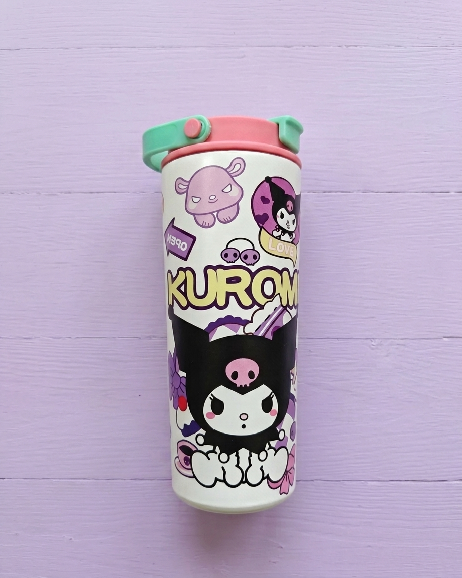 A Kuromi-themed insulated tumbler with a white body decorated with black, pink, and purple cartoon characters and the text 'KUROMI'. It features a pink lid and a mint green flip straw, set against a light purple wooden background.