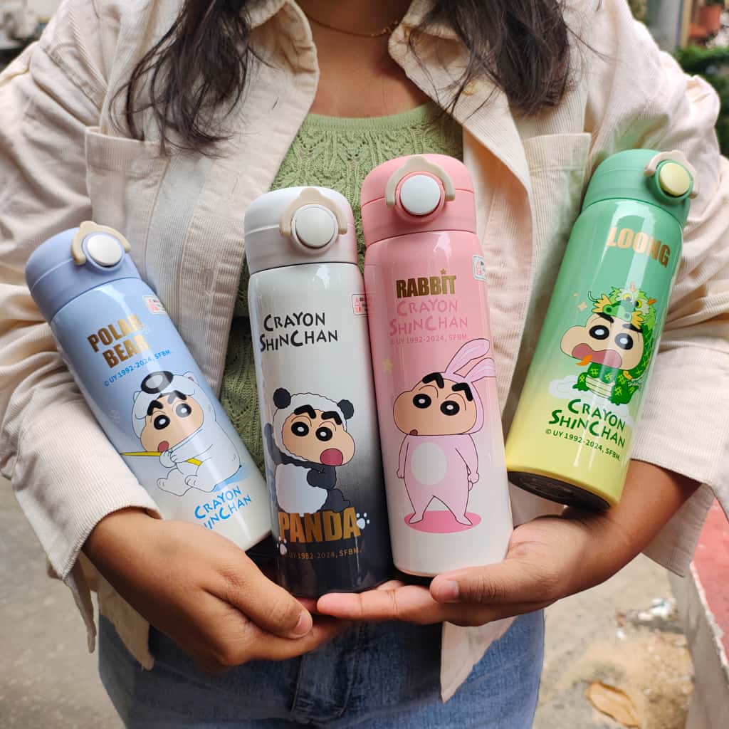 Four colorful water bottles with Crayon Shinchan designs held by a person.