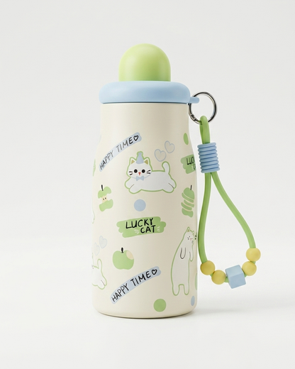 A cute, insulated stainless steel water bottle with a light green lid and a matching green wrist strap. The bottle body is cream-colored with illustrations of a white cat, green apples, and text reading 'HAPPY TIMED' and 'LUCKY CAT'.