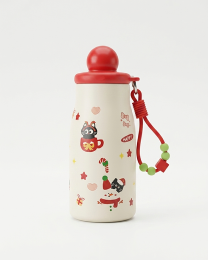 A cream-colored insulated water bottle with a red lid and a red carrying strap adorned with green beads. The bottle is decorated with festive Christmas illustrations, including a cat in a mug, candy canes, stars, and a Santa hat.