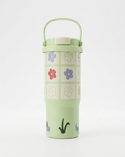 A light green insulated travel tumbler with a matching carry handle lid, decorated with a grid of colorful flowers and small botanical illustrations near the base, set against a plain white background.
