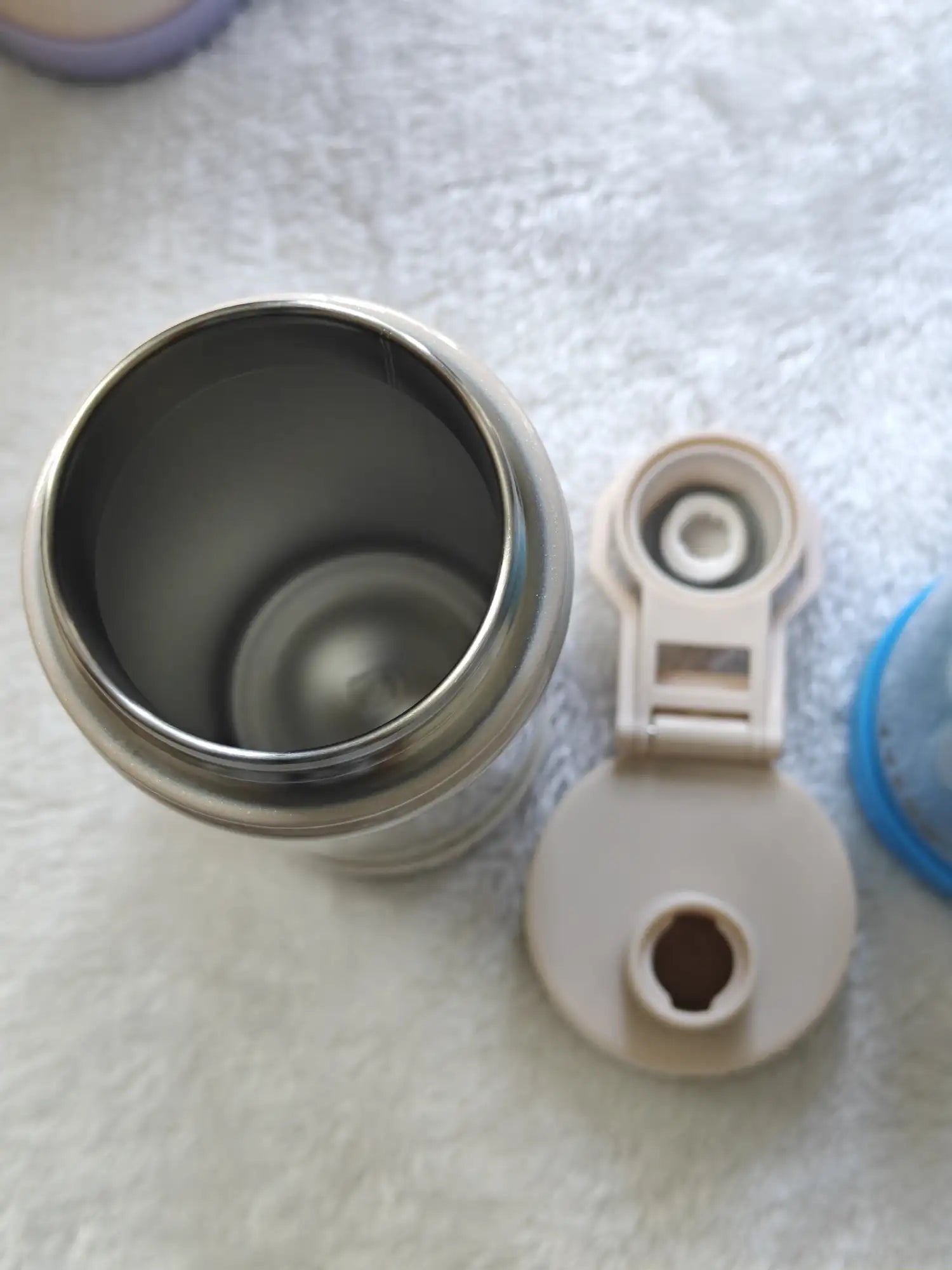 Metal container with a white cap on a textured surface