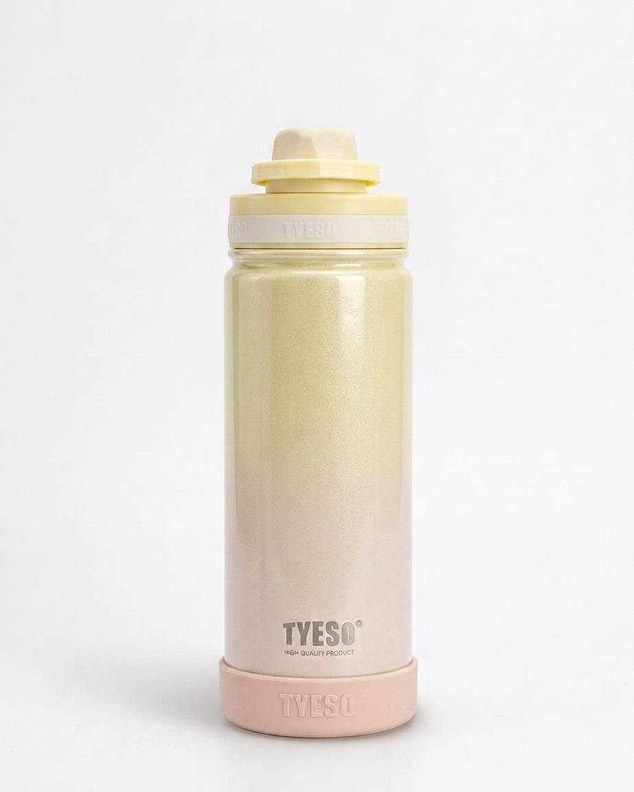 A TYESO insulated water bottle with a pale yellow to soft pink ombré finish, featuring a matching pale yellow lid and a pink base, set against a plain white background.