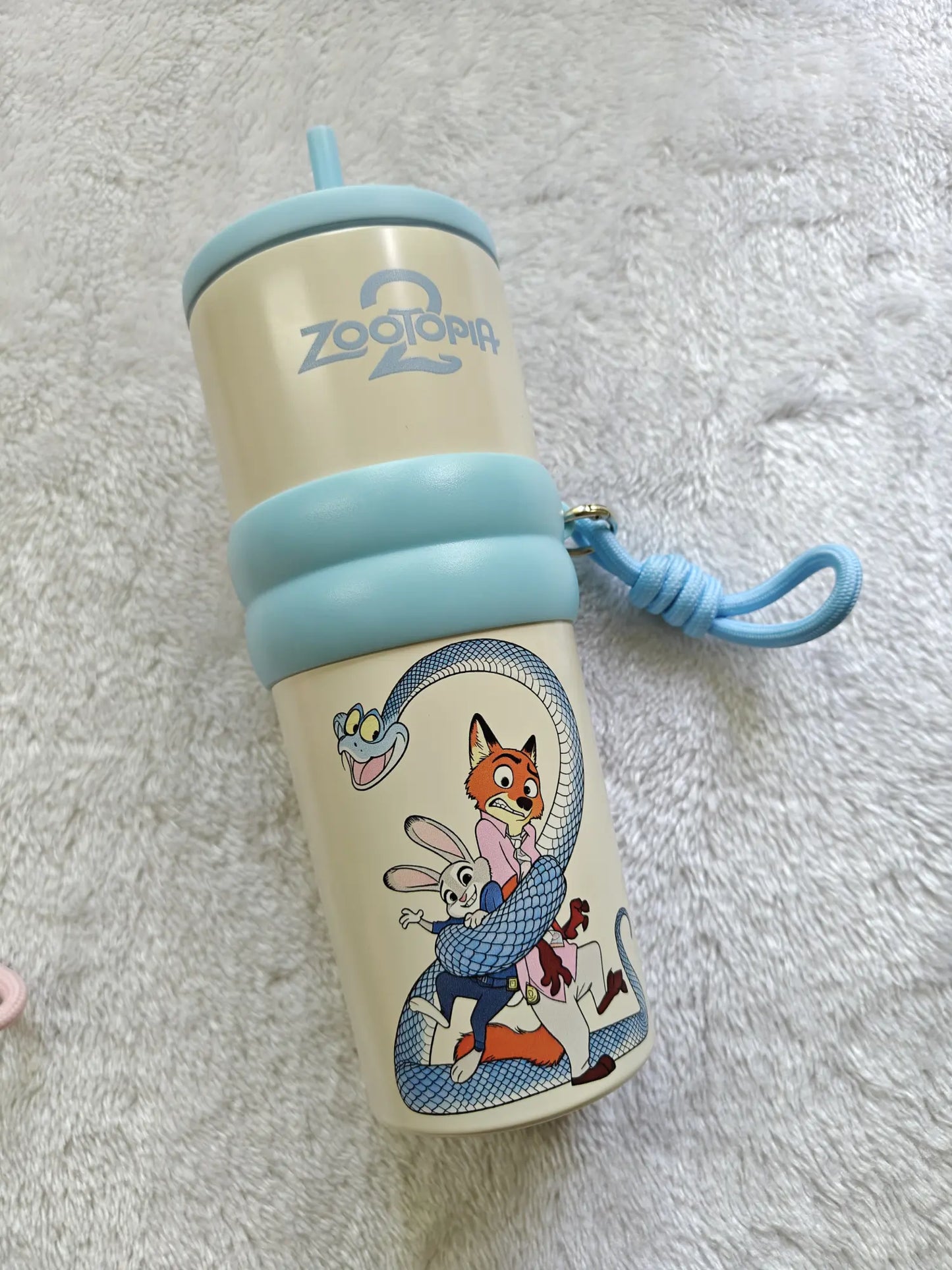 Children's tumbler with cartoon characters on a soft white background
