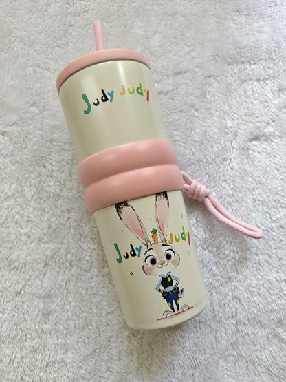 Tumbler with cartoon character and 'Judy Judy' text on a textured surface